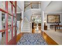 Welcoming foyer with hardwood floors, staircase, and views into the dining and living areas at 4492 Arbor Crest Ct, Suwanee, GA 30024