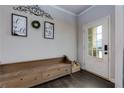 Welcoming entryway with a decorative bench, stylish decor, and a glass-paneled front door at 4675 Dandelion Way, Cumming, GA 30040
