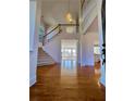 Elegant foyer featuring hardwood floors, high ceilings, a grand staircase, and a chandelier at 11365 Donnington Dr, Duluth, GA 30097