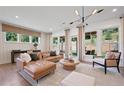 Bright and airy living room with large windows, neutral decor, and stylish furnishings at 130 Briargate Dr, Johns Creek, GA 30097