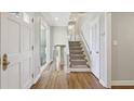 Inviting entryway featuring hardwood floors and stairs leading to the upper level at 3902 Sheldon Ne Dr, Atlanta, GA 30342