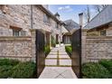 Charming home entrance with a brick facade, manicured landscaping, and a walkway at 225 Dovecrest Dr, Atlanta, GA 30305