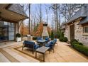 Spacious patio featuring a cozy seating area with a fire pit and a built-in grilling area for outdoor enjoyment at 225 Dovecrest Dr, Atlanta, GA 30305