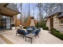 Expansive patio area with comfortable seating, an outdoor fireplace, and a built-in grill at 225 Dovecrest Dr, Atlanta, GA 30305