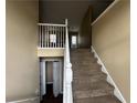 A carpeted staircase is the focus point as one enters the home at 2655 Fort Apachee Trl, Dacula, GA 30019