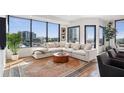Bright living room with floor-to-ceiling windows and a large comfortable sectional sofa at 2828 Peachtree Nw Rd # 1002, Atlanta, GA 30305