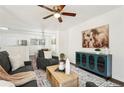 Bright living room featuring a comfortable couch, stylish furniture, and a ceiling fan at 4042 Sweetbriar Ln, Forest Park, GA 30297
