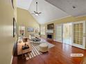 Bright living room with vaulted ceilings, fireplace, hardwood floors and access to patio at 439 Emerald Trce, Jonesboro, GA 30236