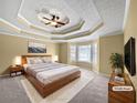 Spacious main bedroom with decorative ceiling, large window and comfortable carpeting at 439 Emerald Trce, Jonesboro, GA 30236