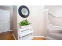 Hallway featuring staircase, clock and decorative shelving at 4570 Grove Park Nw Way, Acworth, GA 30101