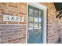 Inviting front door with a classic design, accented by a brick facade and visible address number at 5629 Kingsport Dr # 11, Atlanta, GA 30342