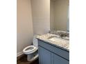 Modern half-bath with granite counters and sleek gray vanity at 903 Jackson Oak Place, Villa Rica, GA 30180