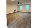 Spacious living room with wood floors, ceiling fan, and natural light from two windows at 903 Jackson Oak Place, Villa Rica, GA 30180
