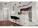 Modern kitchen with marble island, sleek white cabinets, and stainless steel appliances at 2828 Peachtree Nw Rd # 701, Atlanta, GA 30305