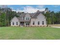 Charming two-story home featuring a mix of brick and siding, complemented by a well-maintained lawn at 31 Homesite Cooper E Cv, Fayetteville, GA 30214
