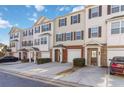 View of townhomes with vinyl siding, brick accents, and attached garages at 406 Patina Se # 23, Mableton, GA 30126