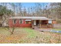 Charming single-story home with a sloped yard and a metal roof at 4166 Hall Se St, Acworth, GA 30102