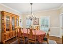 Traditional dining room with hardwood floors, a chandelier, and a wooden china cabinet, perfect for entertaining at 2819 Saddlebrook Nw Way, Marietta, GA 30064