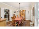 Elegant dining room features hardwood floors, a chandelier, and a wooden china cabinet, perfect for entertaining at 2819 Saddlebrook Nw Way, Marietta, GA 30064