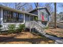 Inviting two-story home with a charming front porch, trimmed windows, and well-kept landscaping at 3594 Vinyard Way, Lawrenceville, GA 30044
