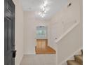 Welcoming foyer featuring tile flooring and views of hardwood floors in the adjacent living area at 107 Vinings Forest Se Cir, Smyrna, GA 30080
