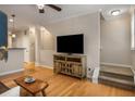 Open concept living room showcasing hardwood floors, stairs, and ample natural light at 380 Grant Se Cir # 110, Atlanta, GA 30315