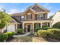 Charming two-story home with a welcoming front porch, stone details, and well-maintained landscaping at 4770 Shiloh Springs Rd, Cumming, GA 30040