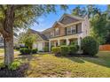 Lovely home featuring stone accents, a well-kept lawn, and a covered front porch at 4770 Shiloh Springs Rd, Cumming, GA 30040