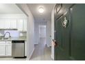 Condo entryway featuring stainless appliances, granite countertops, and wood floors at 300 Johnson Ferry Ne Rd # B113, Atlanta, GA 30328