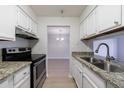 Eat-in kitchen featuring granite counters, stainless steel appliances, and wood floors at 300 Johnson Ferry Ne Rd # B113, Atlanta, GA 30328