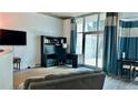 Cozy living room featuring a home office setup and large sliding glass doors at 943 Peachtree Ne St # 704, Atlanta, GA 30309