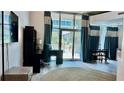 Bright living room with an office setup and sliding glass doors to the outside at 943 Peachtree Ne St # 704, Atlanta, GA 30309
