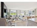 Bright and airy living room featuring hardwood floors, large windows, and neutral decor and furnishings at 990 Sutherland Lane (Lot 34), Lawrenceville, GA 30043