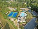 A vibrant community pool, tennis courts, and lush landscaping offer a resort-like experience for residents at 1023 Spruce Creek Ln, Lawrenceville, GA 30045