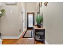 Well-lit foyer features beautiful hardwood floors, neutral wall paint, and stylish furniture accents at 4144 D Youville Trce, Atlanta, GA 30341
