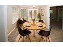 Inviting dining area with a round table, seating for four, and natural light at 711 Cypress Pointe St, Johns Creek, GA 30022