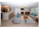 Spacious living room with a fireplace, a ceiling fan and comfortable seating at 711 Cypress Pointe St, Johns Creek, GA 30022