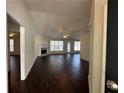 Spacious living room with hardwood floors, a fireplace, and large windows providing natural light at 275 Circle Rd, Dacula, GA 30019