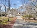 Long paved driveway leading to a well maintained home on a sprawling, wooded lot on a clear day at 444 Pineview Dr, Canton, GA 30114