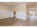 Bright and airy living room features stylish wood flooring and neutral paint at 1587 Sungrown Way, Mcdonough, GA 30253