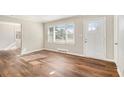 Bright living room with hardwood floors, a large window, and a stylish front door at 2716 Wedgewood Ter, Decatur, GA 30032