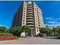 A modern building with balconies is framed by a colorful flower bed in the foreground at 3286 Northside Nw Pkwy # 304, Atlanta, GA 30327