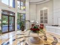 Grand lobby features marble floors, soaring ceilings, and a round table display with plants at 3286 Northside Nw Pkwy # 304, Atlanta, GA 30327