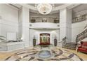 An elegant lobby with a crystal chandelier, staircase, and marble floors at 3286 Northside Nw Pkwy # 304, Atlanta, GA 30327
