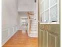 Inviting foyer with hardwood floors, staircase, and plenty of natural light with entry to a spacious living area at 3600 Elkhorn Nw Ct, Duluth, GA 30096