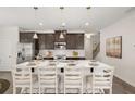 Spacious kitchen island with white countertop and seating, stainless appliances and pendant lighting at 1385 Elowen Dr, Austell, GA 30168