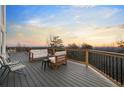 Outdoor deck area with seating offering panoramic views of the distant landscape at sunset at 4349 Highborne Ne Dr, Marietta, GA 30066