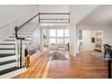 Grand foyer with hardwood floors, staircase, and view into the bright living room with large windows at 4349 Highborne Ne Dr, Marietta, GA 30066