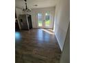 Bright dining room with French doors leading to backyard, accented by modern flooring and stainless steel refrigerator at 4906 Kellys Mill Nw Dr, Lilburn, GA 30047
