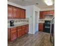 Traditional kitchen with granite counters, stainless appliances, and wood cabinets and flooring at 4906 Kellys Mill Nw Dr, Lilburn, GA 30047